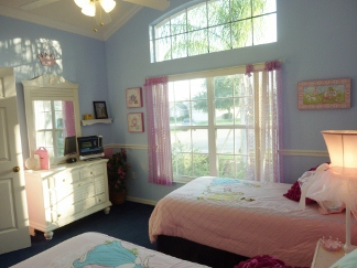 The Princess room has a vanity, TV, Mirror, Ceiling fan. 